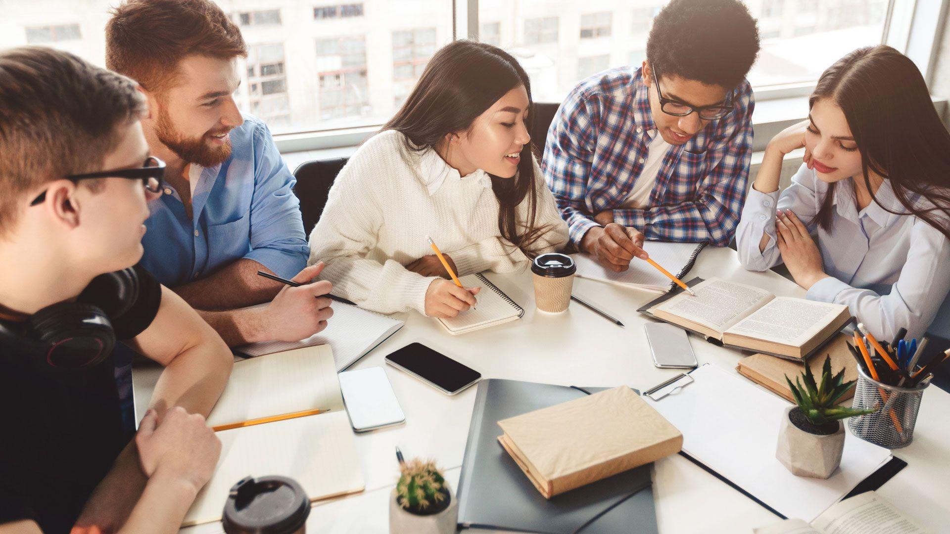 Students learning together sitting at a table