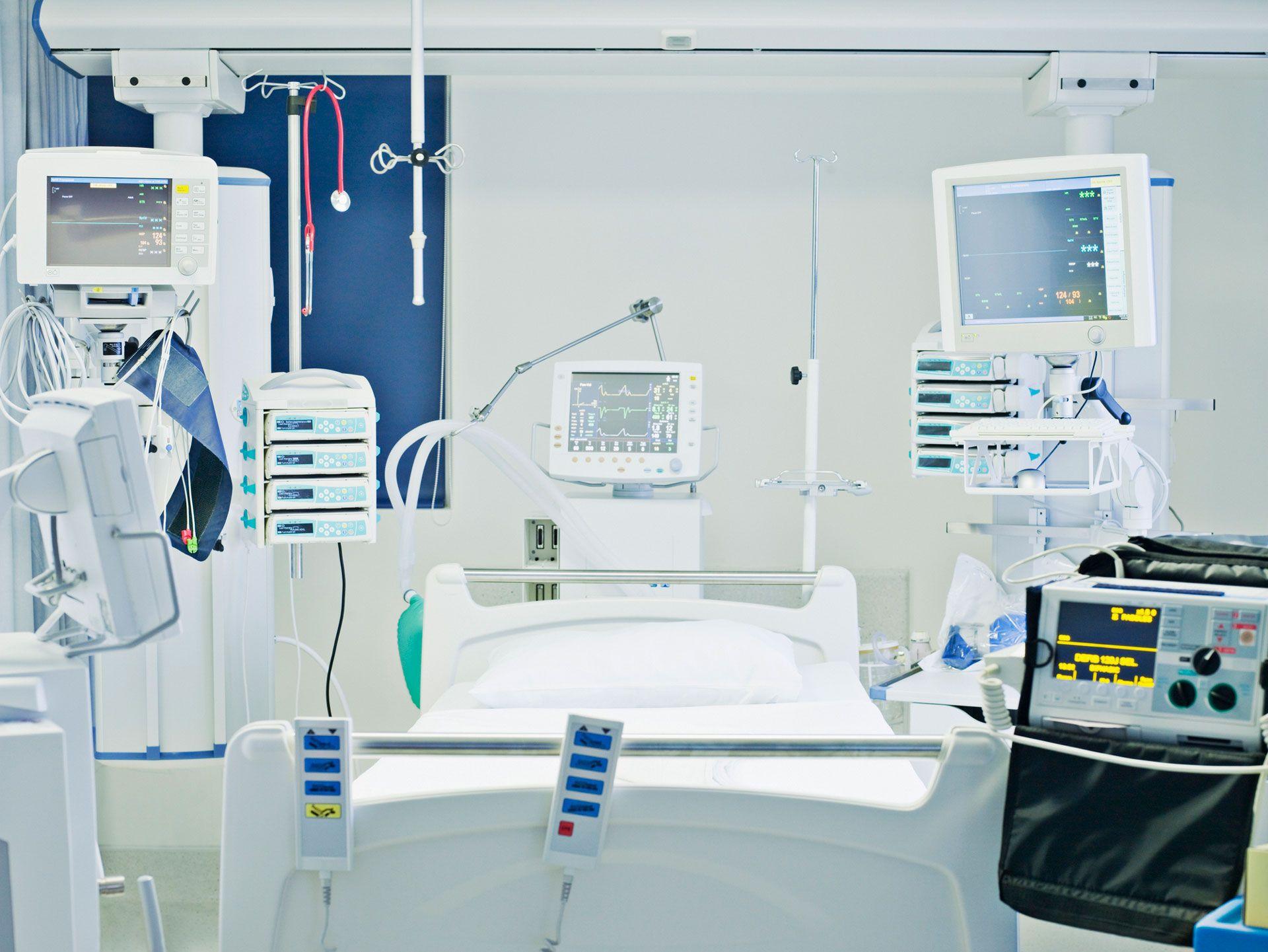 Hospital room with a bed and several medical devices