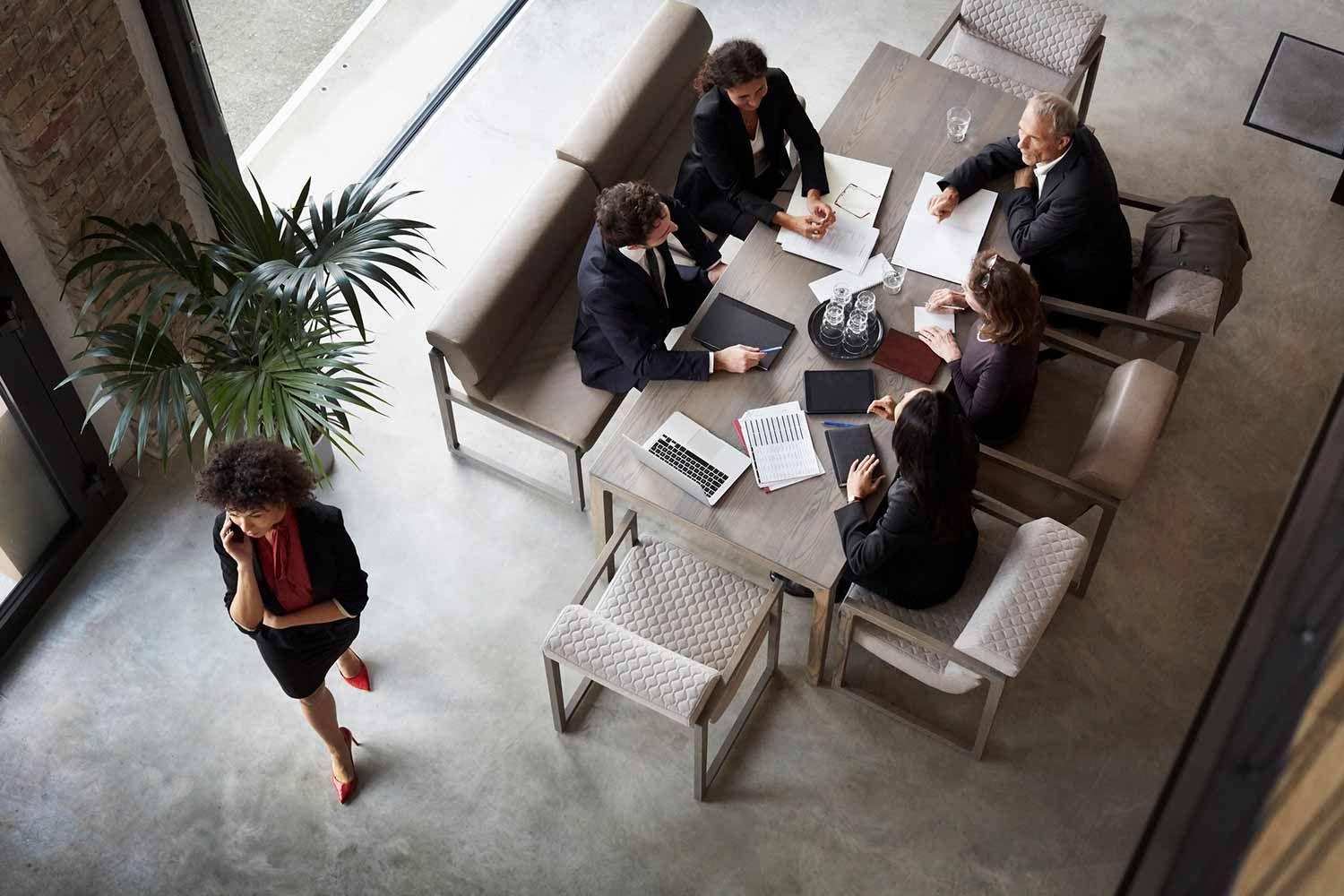 Five people conference at a big table