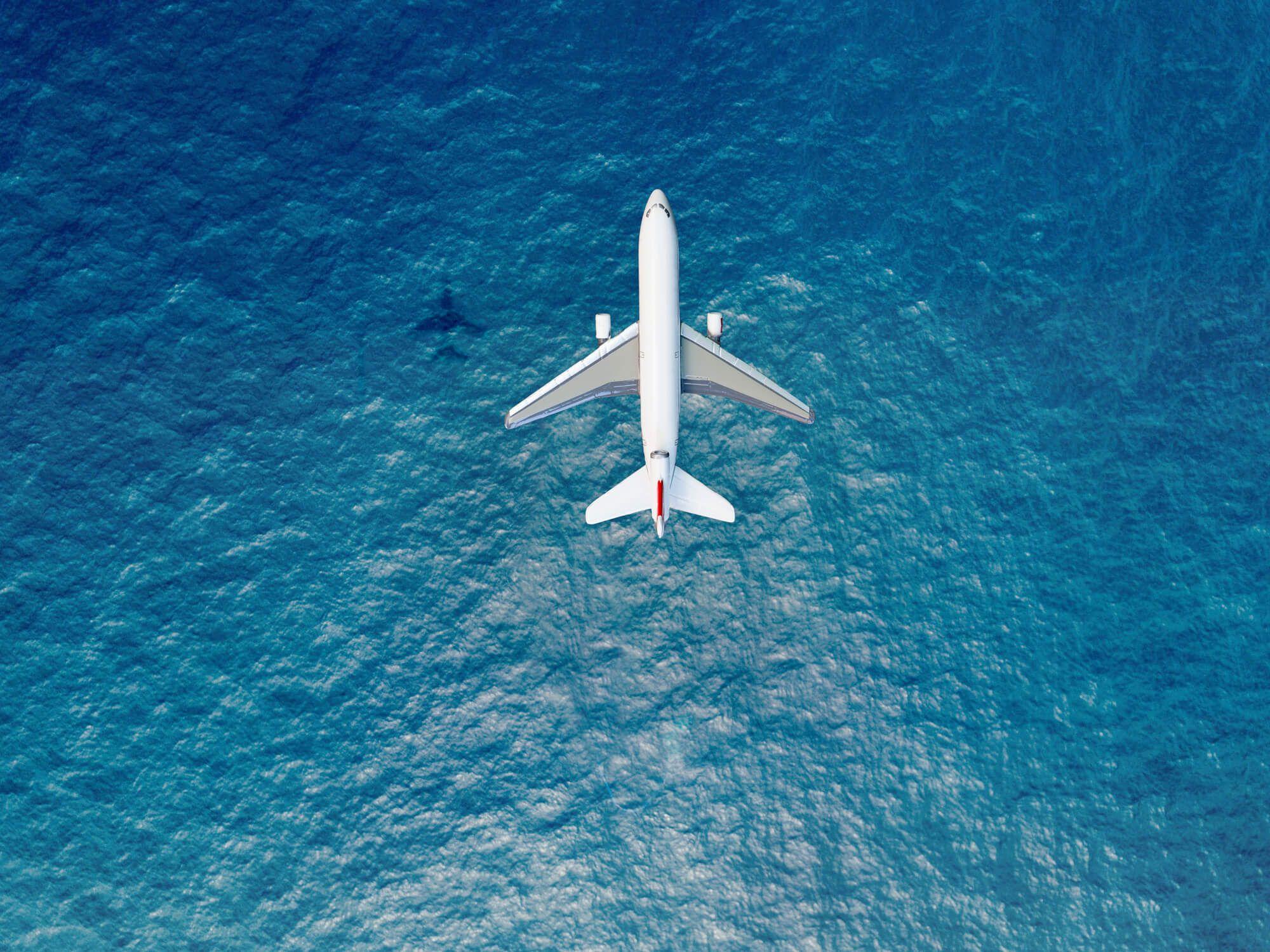 Birds-view of an airplane above the sea